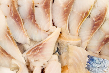 Pieces of fish fillet. Canned fish. Herring fillet close-up.