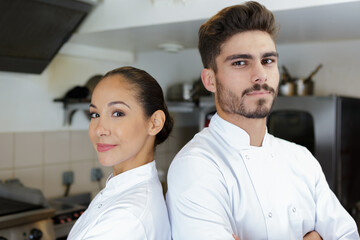 portrait of male and female chefs back to back