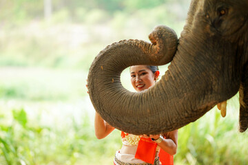 Closeup a beautiful Thai young lady with Thai northern traditional dress acting and play for phot...