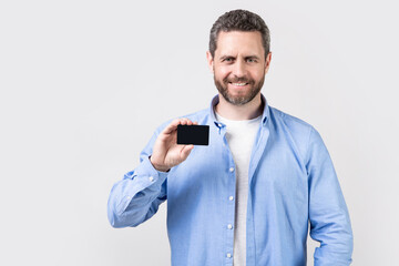 smiling man with business credit in studio. man holding business credit.