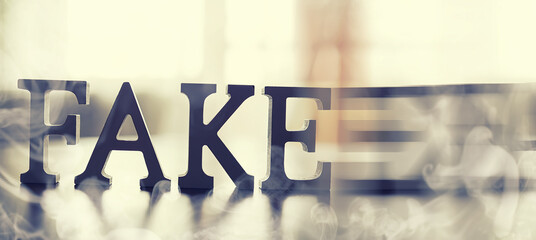 The concept of modern information technology. Fake and facts in the news. The letters spelled the...