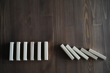 Closeup thick domino wood block in a row stop the falling, be stable in crisis, business solution concept