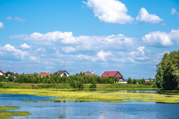 Private houses on the lake shore on a summer day.