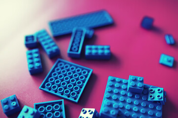 A scattering of constructor elements for children. Colored blue bricks from the puzzle.