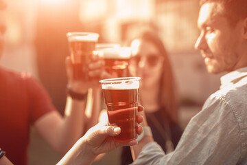 Group of friends enjoying cold beer at a backyard party.