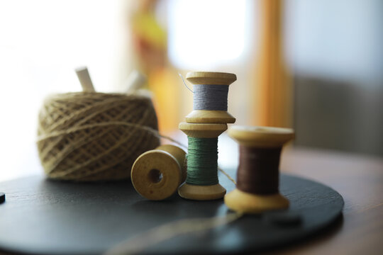 Old scissors, spools of colored thread, centimeter and tailors chalk, flat lay, concept of sewing clothes