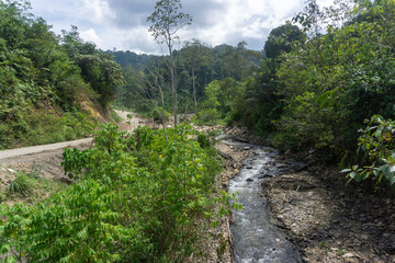 Landscape of small river and village road with beautiful mountain background.
