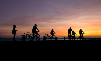Fototapeta na wymiar Silhouette of cyclist biking at the sunset