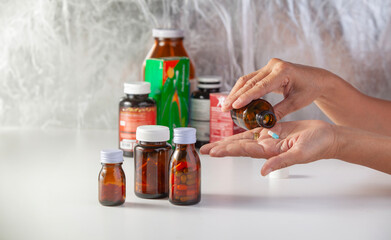 hand holding a bottle of medicine