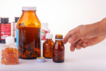 medicine bottle in hand  and bottles of medicine white background.