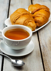 Close-up of croissants on a dark background. Fresh and delicious French pastries, bakery concept, close-up image. tea .