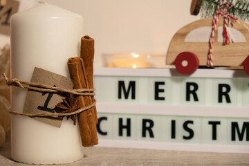Candles with advent calendar Lightbox with text MERRY CHRISTMAS Traditional Burning Christmas Wax Candles with numbers counting down for Christmas. Beautiful Advent At Home. Festive Candlelight And