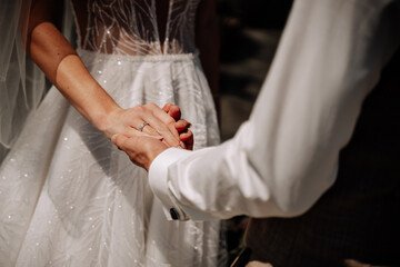 Groom Holding Bride Hand on Marriage Ceremony. Man in Ceremonial Costume and Woman in Wedding Dress Standing Togetherness. Couple Romantic and Sensual Celebrative Event Photography