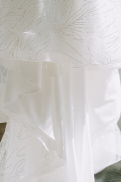 Bride Wedding Textile Dress Close-up Photography. Silk Bridal Garment with Elegant Attractive Tracery Pattern. Fashionable Traditional Gown Clothes Tissue for Celebrate Romantic Event.