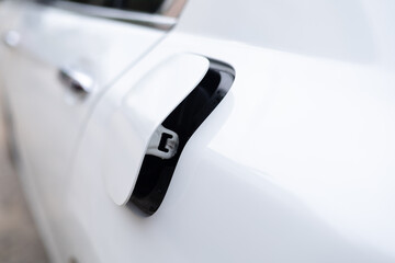 Close-up the cap of fuel tank has opened of the white car for filling the oil gasoline or diesel...