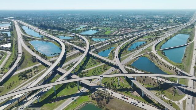 Above view of wide highway crossroads in Miami, Florida with fast driving cars. USA transportation infrastructure concept