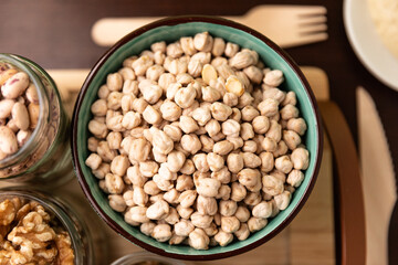 bowl full of chickpeas on wooden table background. Top view.