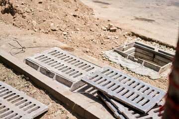 Laying concrete manholes and drain pipes for stormwater system. Connecting a trench drain to a...