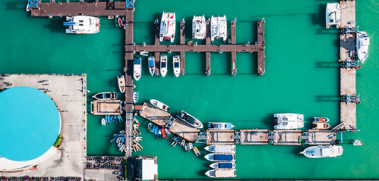Yacht club at Chalong bay, Phuket, Thailand. Aerial view of the yacht parking, A marina lot, Yacht and sailboat is moored at the quay.