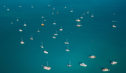 Many boats and yachts in the blue ocean. Aerial view of seascape.