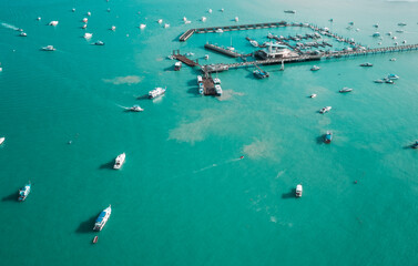 Fototapeta na wymiar Chalong pier phuket in aerial view. Seascape at yacht club with sailboats.