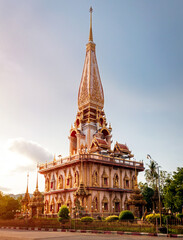 Pagoda in wat chalong or chalong temple at sunset, public place.