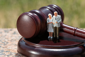 Judge's gavel and figurines of an elderly couple