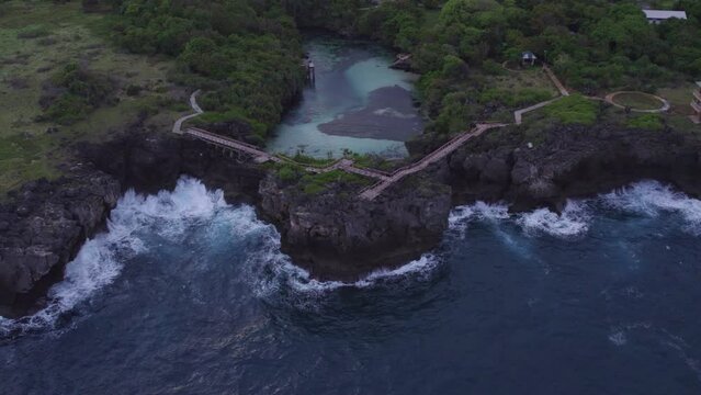 Reveal shot of the famous weekuri lagoon during sunrise with no people at Sumba Island, aerial