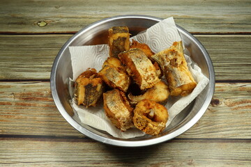 Pile of deep fried yellow tail fish. Famous crispy and crunchy seafood menu in Asian restaurant.