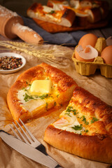 Khachapuri - traditional Georgian cheese and egg filled bread. Close up
