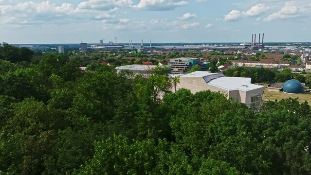 Drone shot of Wolfsburg city , Germany . It's known as the headquarters for Volkswagen and for the Autostadt, an automobile-themed park with a classic-car museum and driving track.