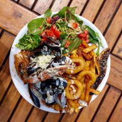 Mediterranean food with shrimps and fried calamari