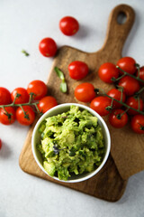 Homemade avocado dip with ripe tomatoes