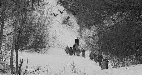 Men Dressed As White Guard Soldiers Of Imperial Russian Army In Russian Civil War s Marching Through Snowy Winter Forest. Historical Reenactment of Civil War. Army on Marching. Black And White Video.