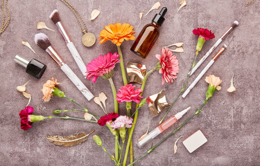 Floral aesthetic flat lay. Dropper bottles, make up brushes, cosmetics, accessories and flowers fine art