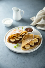 Homemade crepes with chocolate paste and banana