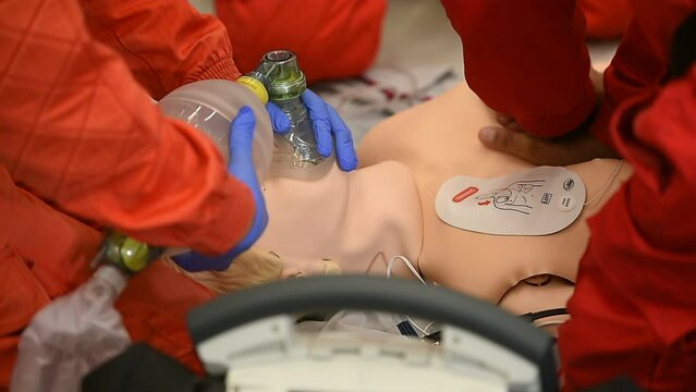 Paramedics simulate emergency intervention on medical training manikin