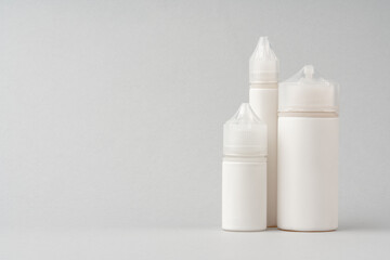 Refill liquid for electronic cigarettes on gray background