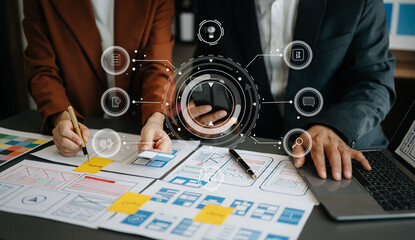 Close up view of UI developer team brainstorming on their project with laptop, smartphone and digital tablet. Creative digital development agency. with virtual icons