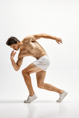 Young handsome Caucasian man wearing homewear posing over white studio background. Concept of men's health, beauty of male body, fashion, ad