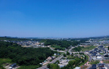 航空撮影した長久手市の森と住宅街の風景