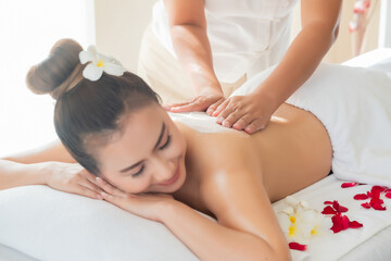 Asia beautiful  woman enjoying a salt scrub massage at the health spa in Thailand - 619725151
