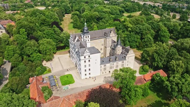 Drone shot of Wolfsburg Castle ( Schloss Wolfsburg ) . The Wolfsburg is a medieval lowland and water castle in North Germany .