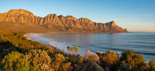 Fototapeten Beauiful evening views of Kogel Bay Beach and Kogelberg Mountain Range forming a beautiful backdrop. Overberg. Western Cape. South Africa © Roger de la Harpe