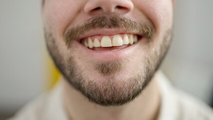 Young hispanic man smiling confident at home