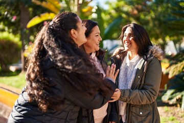 Fototapeta premium Three woman mother and daughters standing together at park