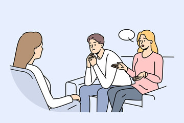 Couple at family therapist in office, sitting on couch talking about problems and quarrels. Woman family therapist helps people get rid of conflicts and misunderstandings in their life together