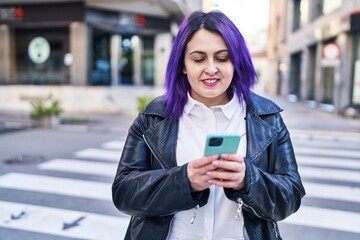 Young beautiful plus size woman smiling confident using smartphone at street