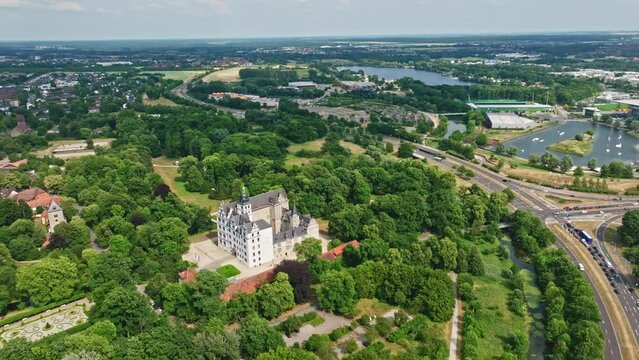 Drone shot of Wolfsburg Castle ( Schloss Wolfsburg ) . The Wolfsburg is a medieval lowland and water castle in North Germany .
