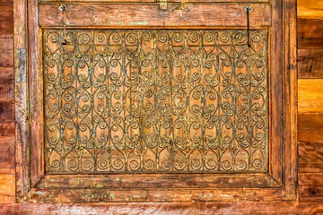 Antique carved wooden windows and wooden wall.